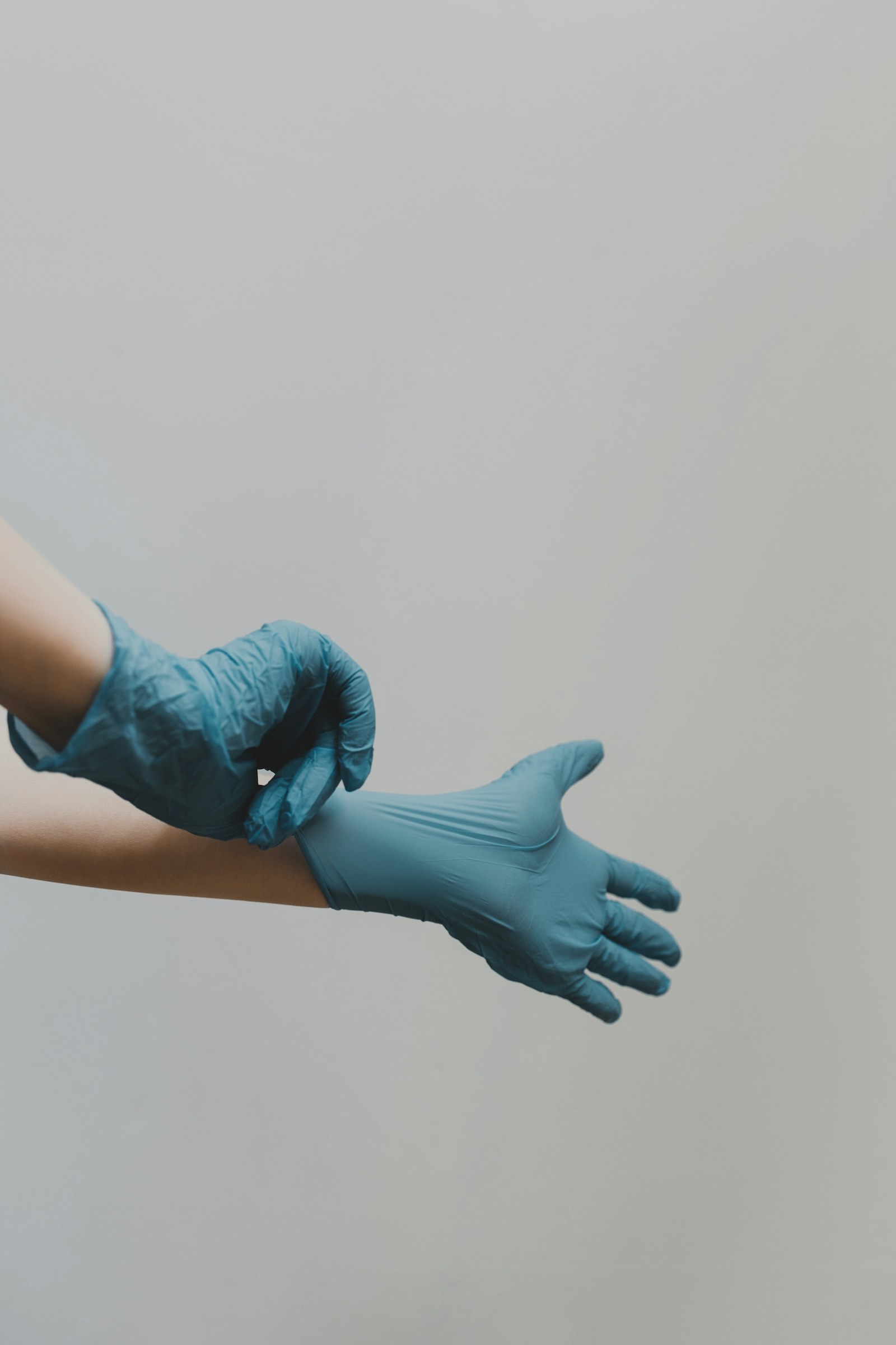 Putting on medical examination gloves