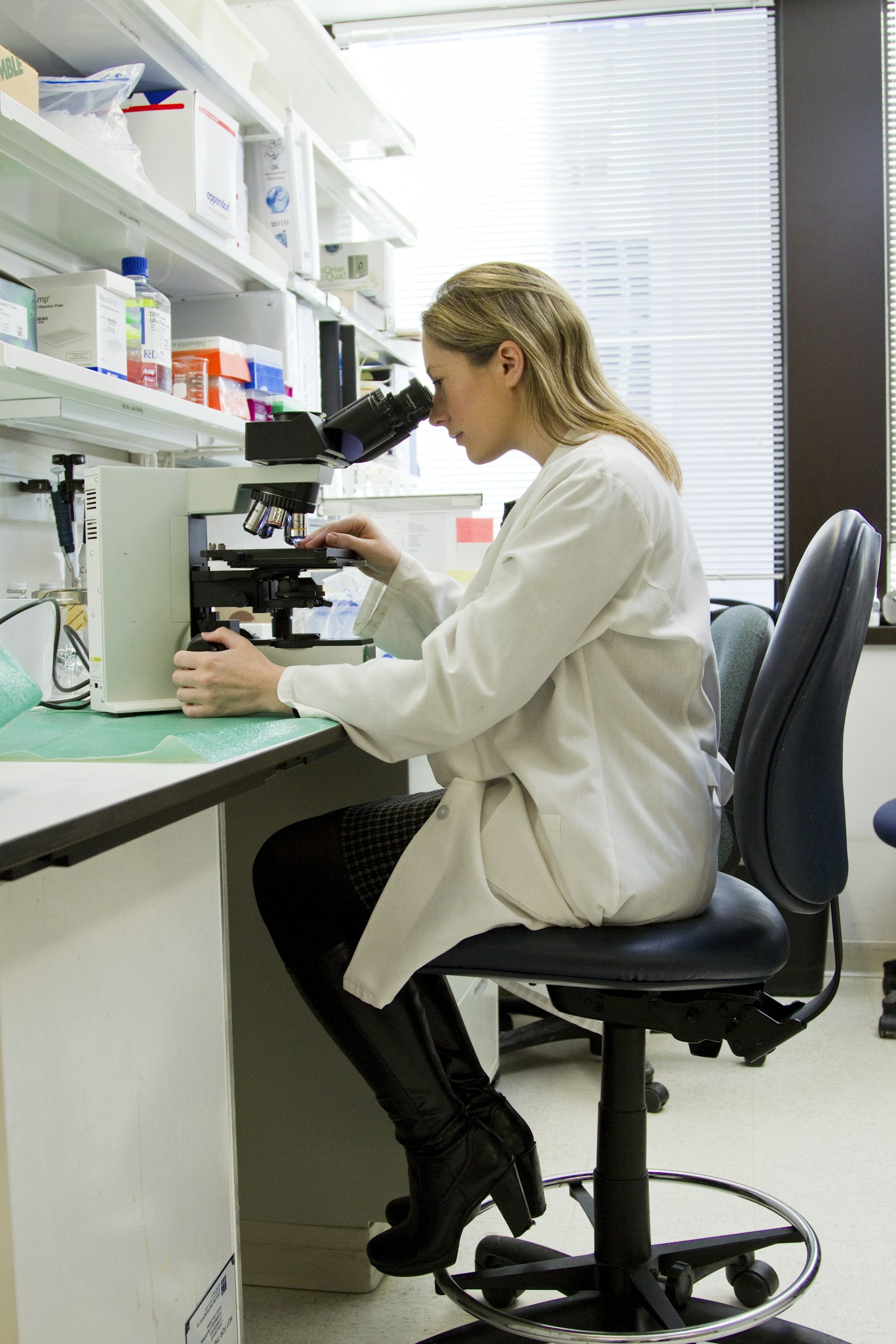 Researcher working at a microscope